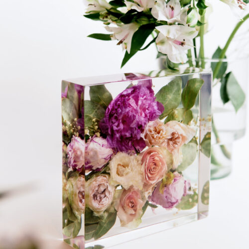 Konservierter Brautstrauß in transparentem Kunstharz-Block mit rosa Pfingstrosen, cremefarbenen Rosen und grünen Blättern, Brautstrauß-Konservierung